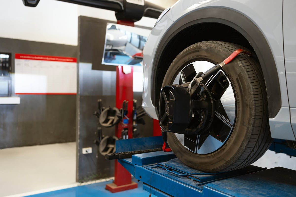 Professional wheel alignment process with precision tools in an automotive service center for safety, performance, and maintenance concepts